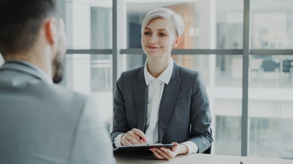 Confident woman interviewing candidate in a modern office.
